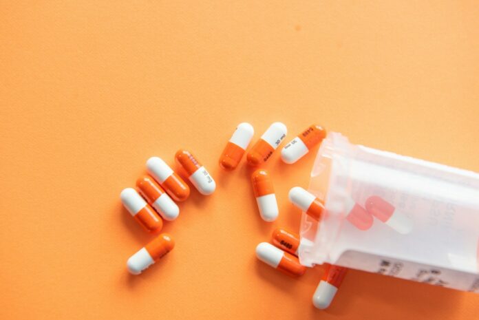 Photo by Christina Victoria Craft orange and white medication pill