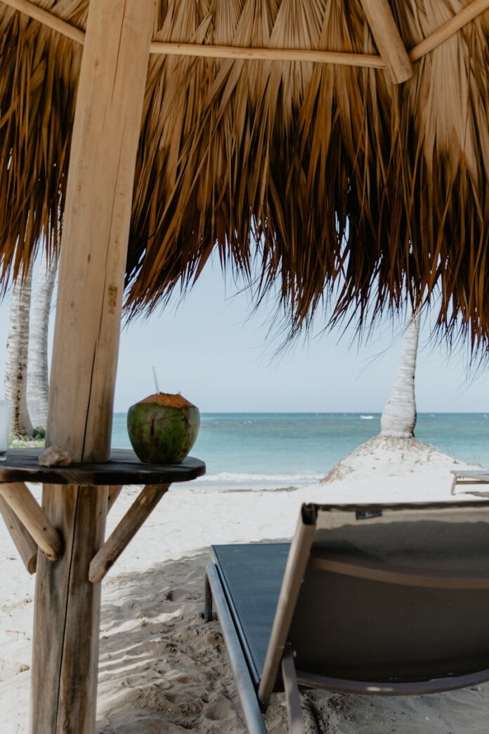 Photo by Kelly Sikkema coconut fruit on white table near beach during daytime