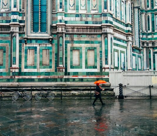 장마철 대비 면역력 강화 운동법 person holding umbrella walking on road