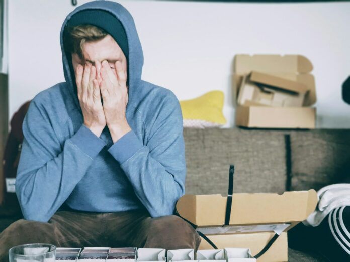 Photo by Christian Erfurt man covering face with both hands while sitting on bench