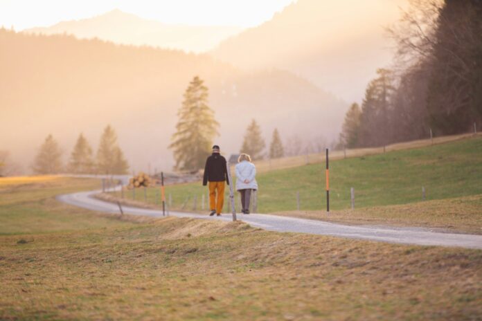Photo by Wedding Dreamz woman in black jacket and white pants walking on road during daytime