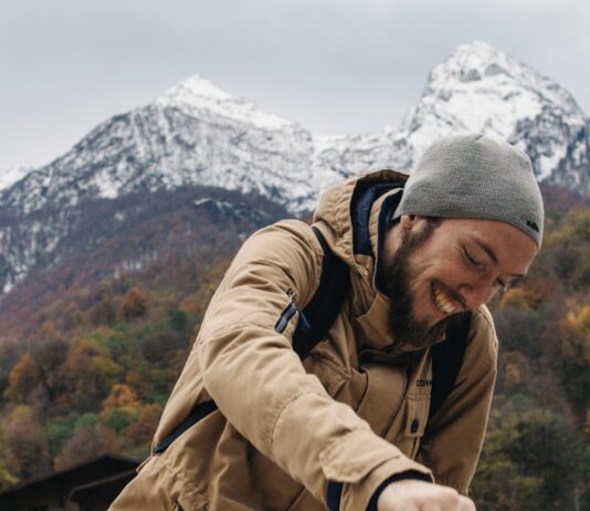 운동으로 건강과 자신감 찾기 man sitting on railings behind snow capped mountain