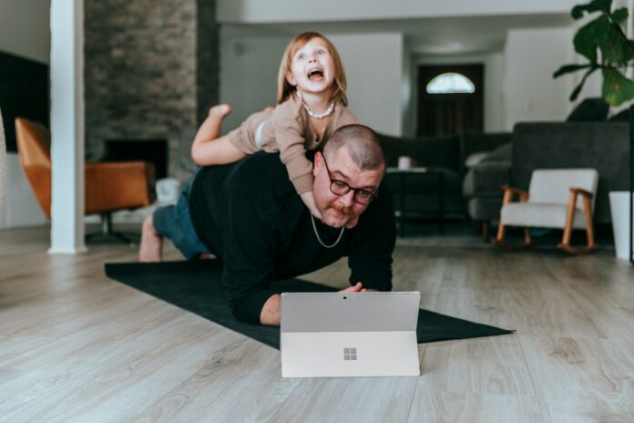 Photo by Surface a man and a little girl playing with a laptop