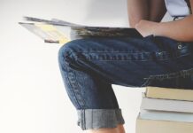 자기계발의 중요성과 꾸준한 성장의 비결 person sitting on stack of books while reading