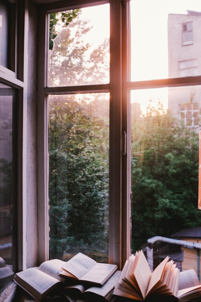 Photo by Ioann-Mark Kuznietsov books beside window during sunset