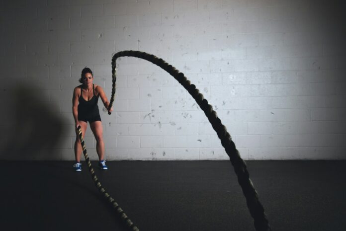 Photo by Scott Webb woman holding brown ropes