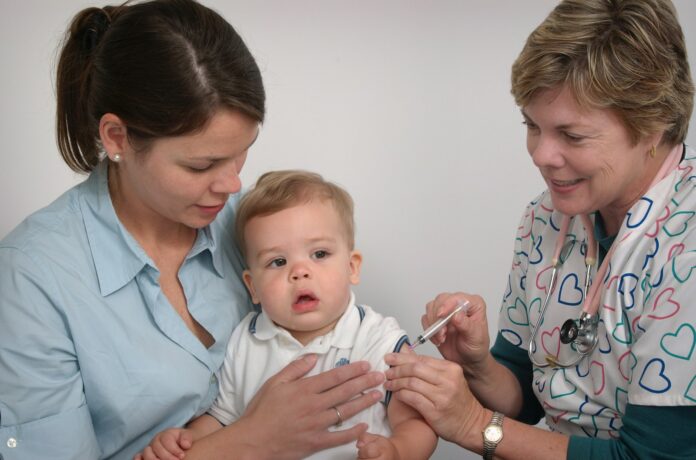 Photo by CDC a baby being examined by a doctor and nurse