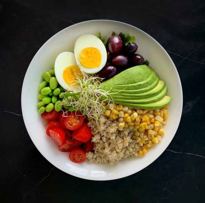 Photo by mk. s a white bowl filled with vegetables and eggs