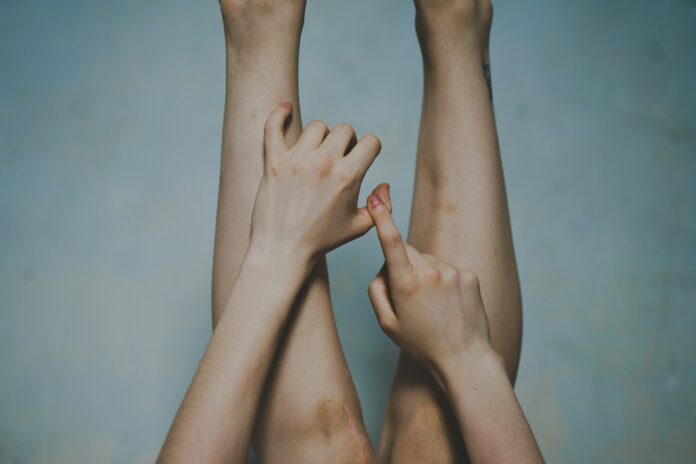 Photo by Fusco Studio two hands reaching up towards each other