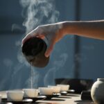 계속되는 피로감, 생활 루틴 점검이 해답…만성피로 줄이는 실천법 person pouring hot water on white cup