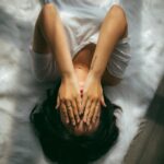 스트레스로부터 내 일상 지키기, 지금 바로 실천하는 건강 루틴 a woman holds her hands over her face